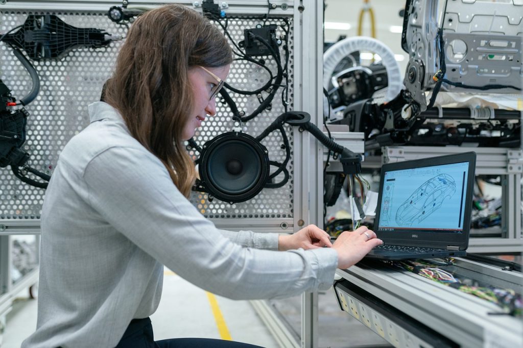 A student working on a laptop in an automotive service technology program