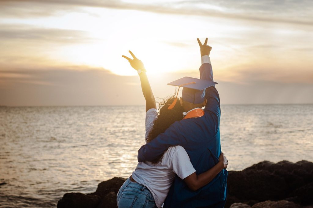 A recent high school graduate facing the ocean, contemplating future career options and educational opportunities.