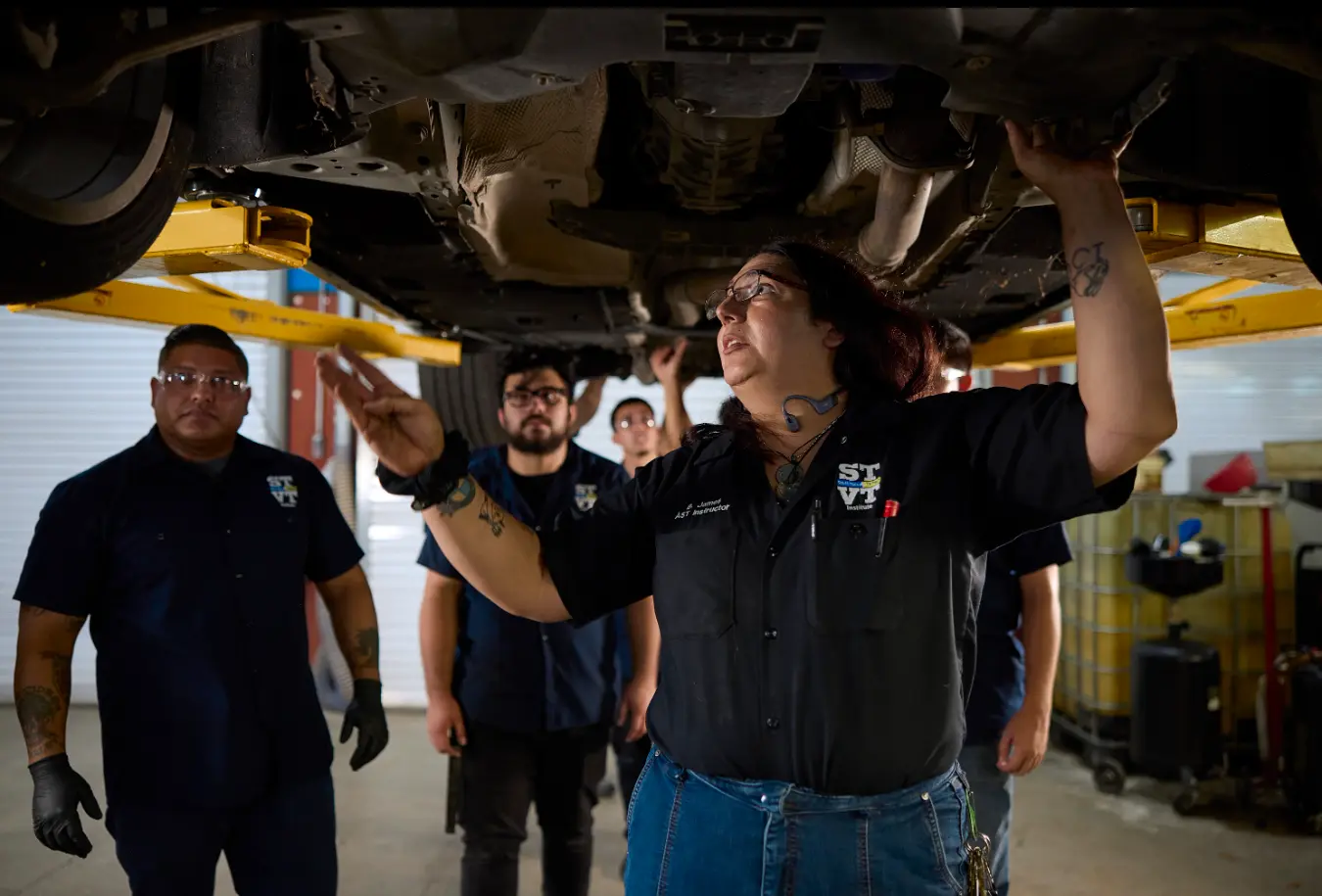 group of stvt students and instructor in auto mechnic setting