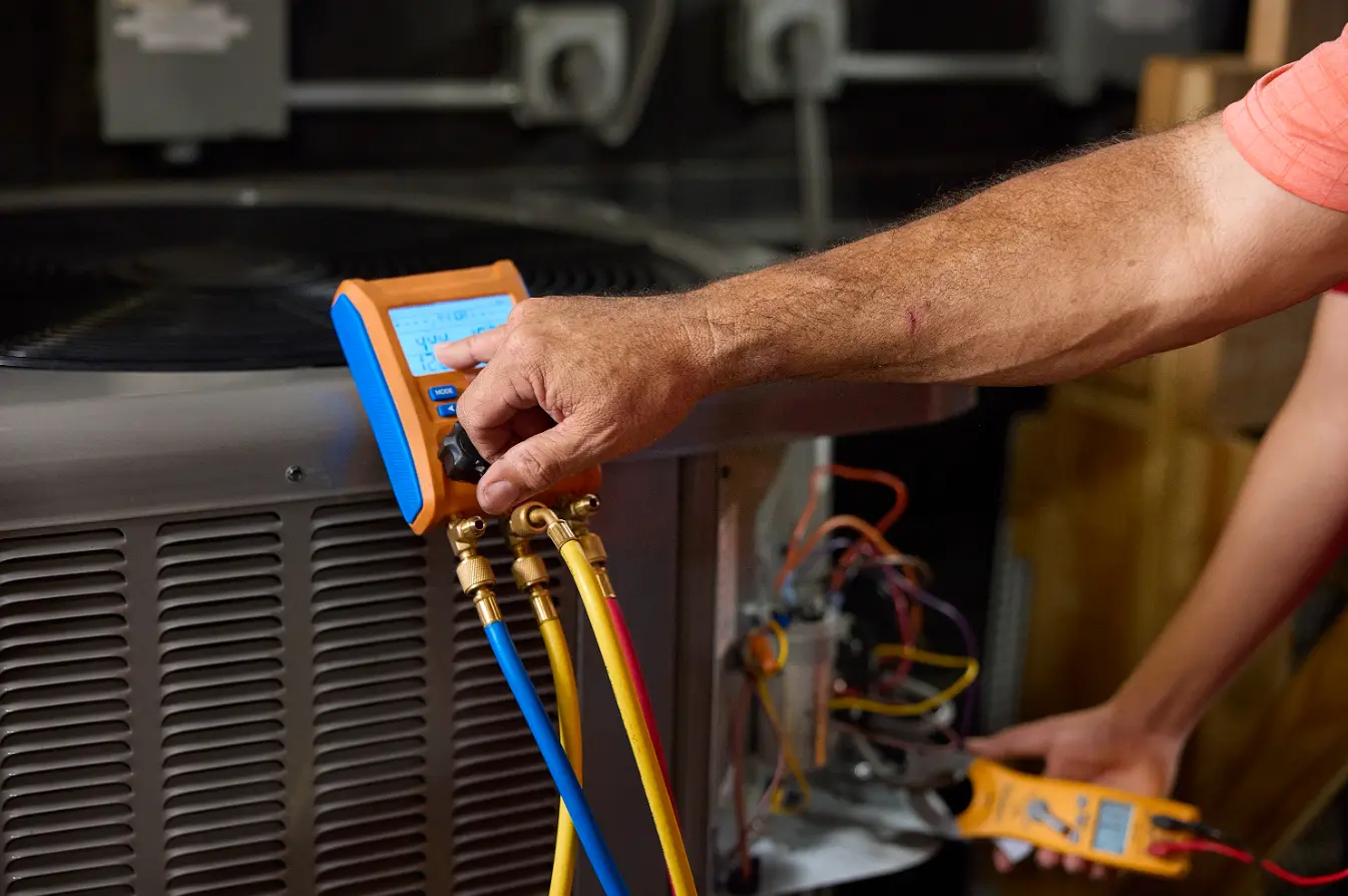 hvac testimonial image, cropped image of a man's hands programming an hvac device