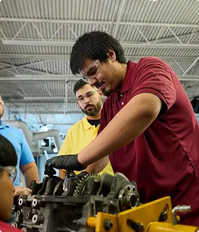 two men in a skilled trades program using power tools
